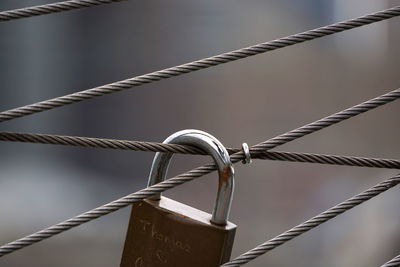 Close-up of padlock on metal fence