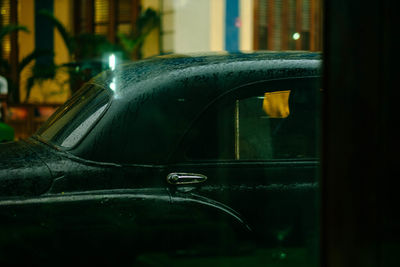 Close-up of wet car in city