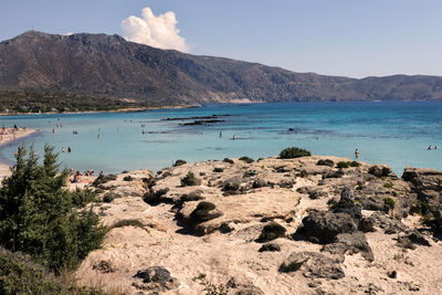 Scenic view of sea and mountains against sky