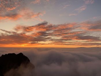 Low angle view of dramatic sky during sunset