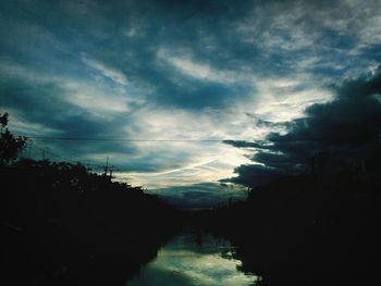 Scenic view of storm clouds over trees against sky