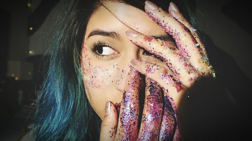 Close-up of woman with glitter on hands