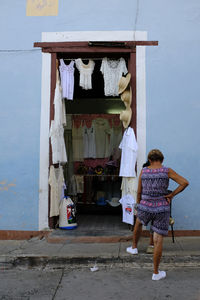 Rear view of people standing against wall