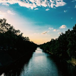 Scenic view of river against cloudy sky