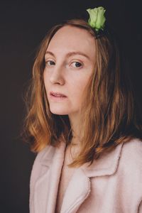 Portrait of beautiful woman against black background