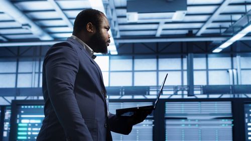Side view of businessman using mobile phone