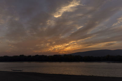 Scenic view of lake against sky during sunset