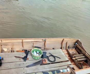 High angle view of food on pier at lake