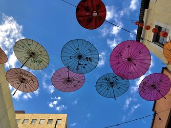 Low angle view of lanterns hanging against sky