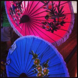 Low angle view of colorful umbrellas hanging on ceiling