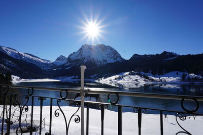 Scenic view of snowcapped mountains against clear blue sky