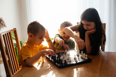 Siblings and woman at home