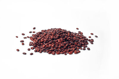 High angle view of coffee beans against white background