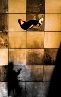 Digital composite image of woman with shadow on floor