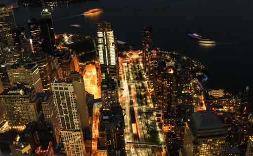 High angle view of illuminated city buildings at night