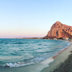 Scenic view of beach against clear sky