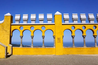 Low angle view of yellow building against blue sky