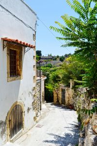 Alley amidst old buildings against sky