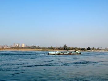 Scenic view of sea against clear blue sky