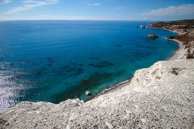 View of calm beach against blue sky