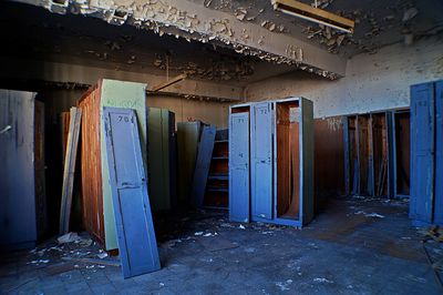 Damaged cabinets in abandoned building