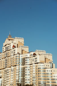 Low angle view of buildings against clear blue sky