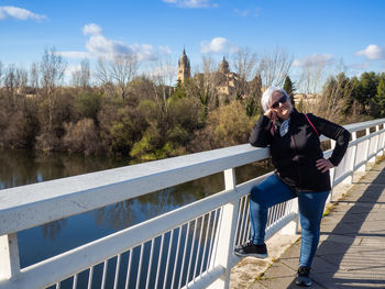 Portrait of man on railing against sky