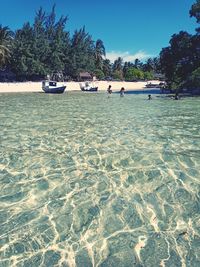 People on beach against sky