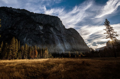 Scenic view of land and mountains against sky