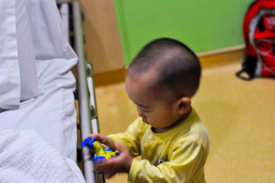 Little boy playing toy in ward