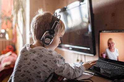 Boy talking with grandmother within video chat on laptop, life in quarantine time, self-isolation