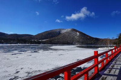 Scenic view of snowcapped mountains against blue sky