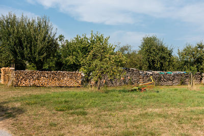 Hay bales on field against sky