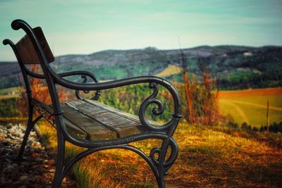 Close-up of park bench on field