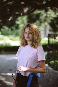 Portrait of a beautiful young woman standing outdoors