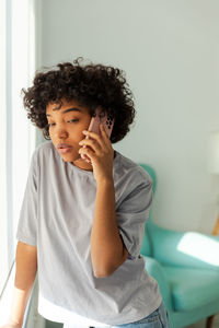 Portrait of young woman using mobile phone