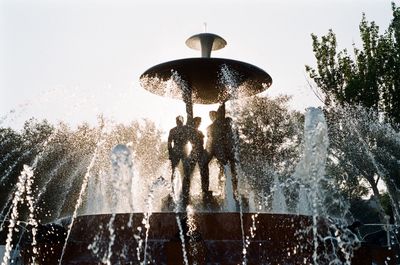 Low angle view of statue fountain against sky