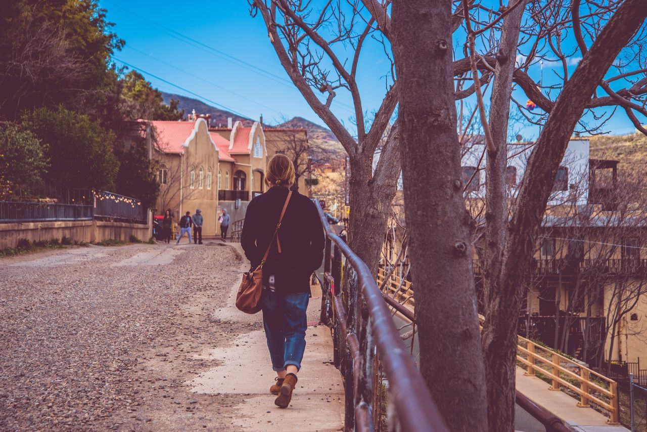 real people, walking, tree, rear view, full length, architecture, lifestyles, built structure, leisure activity, bare tree, one person, building exterior, casual clothing, outdoors, women, day, nature, sky