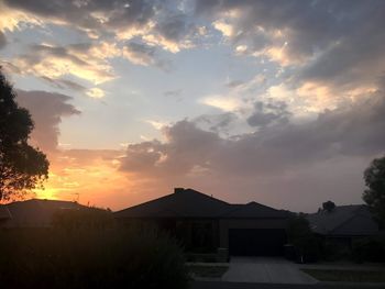 Silhouette buildings against sky during sunset