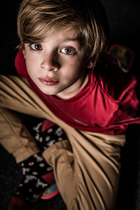 Portrait of cute boy sitting at home