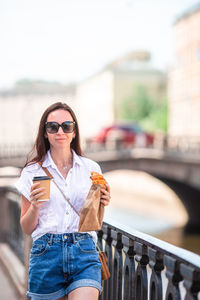 Young woman using mobile phone in city