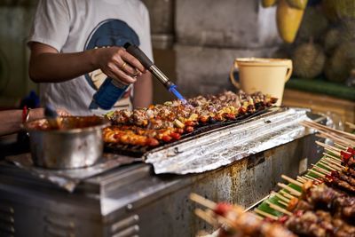 Midsection of man preparing food