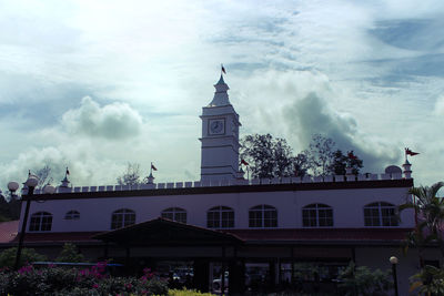 Low angle view of building against cloudy sky