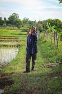 Full length of man standing on field