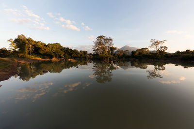 Reflection of trees in lake against sky