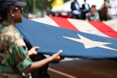 Man holding flag on street in city