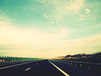 Road passing through dramatic sky