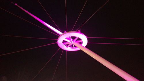 Low angle view of illuminated ferris wheel at night