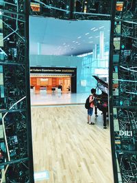 Man standing by modern building in city