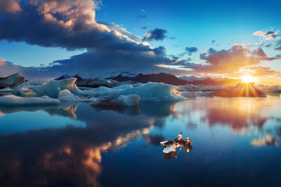 Scenic view of lake against sky during sunset